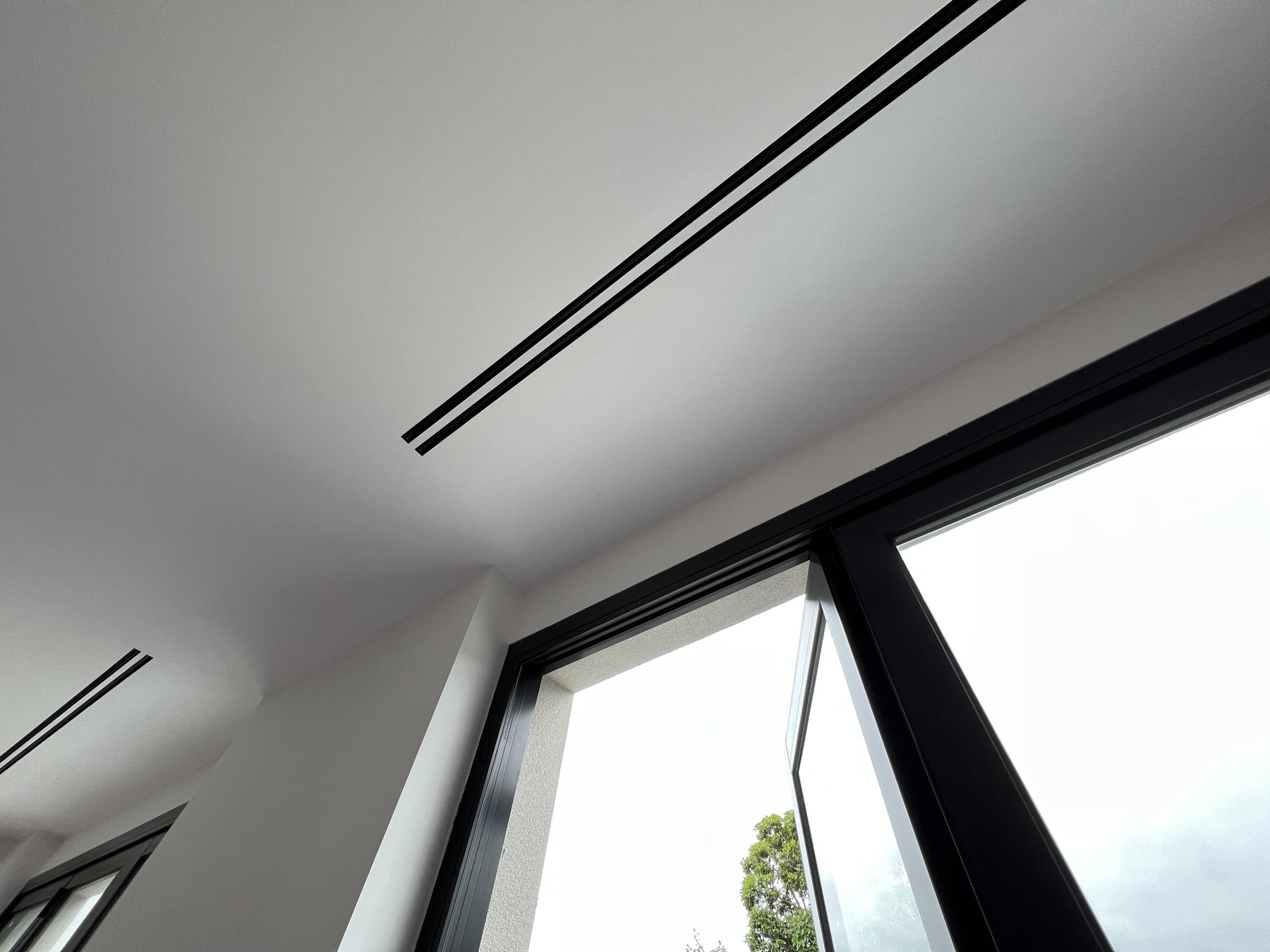 Linear ceiling outlet in a bright living space